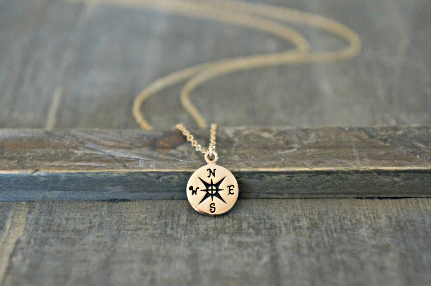 pic of Compass Pendant on wood